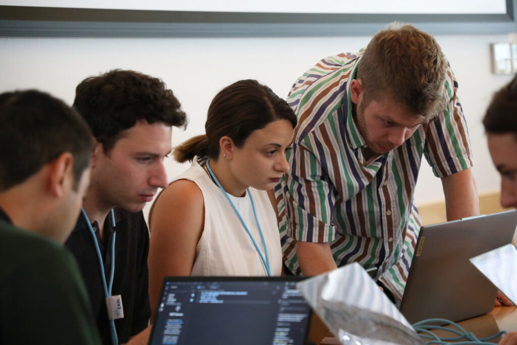 4 people in front of computers