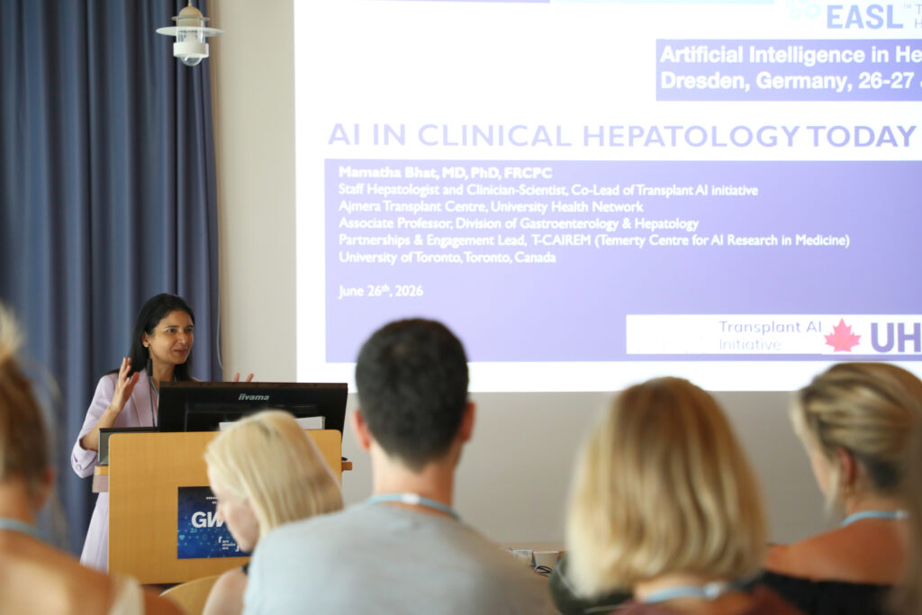 Woman giving a scientific lecture in front of an audience