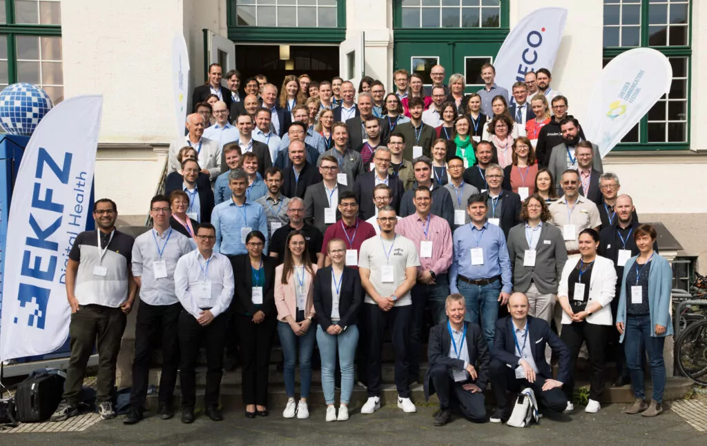 group photo all project partners standing on stairs in front of a building