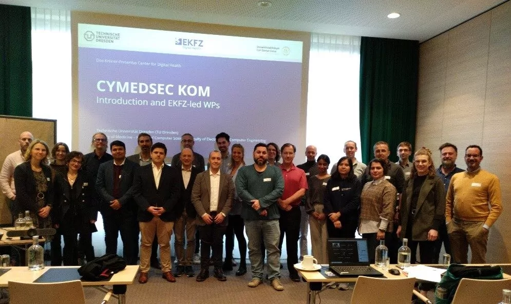 group photo in in front of a presentation display