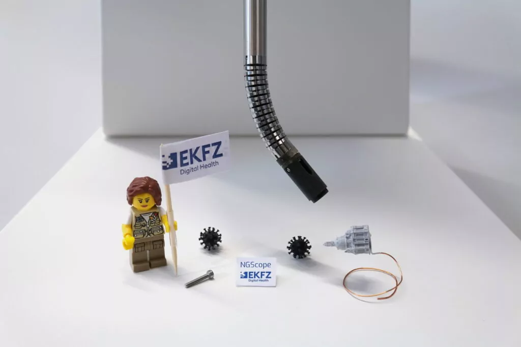 flexible endoscopic tool with lego figure holding a mini paper flag